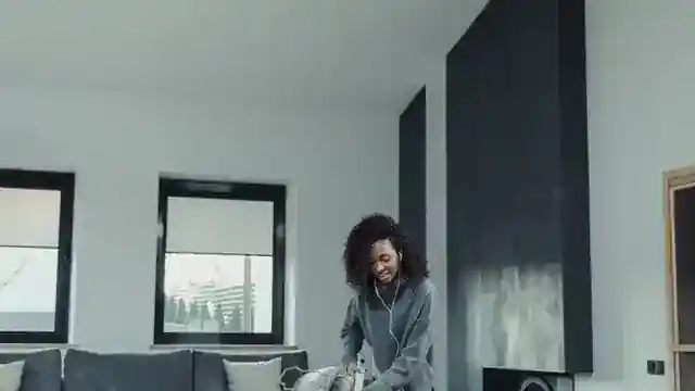Cleaner vacuuming a living room in a Detroit home